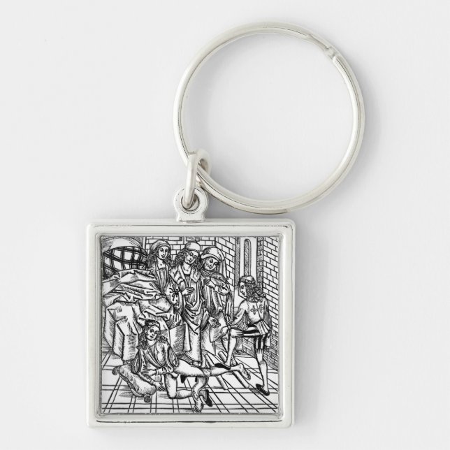 Surgeon directs as an assistant breaks and resets key ring (Front)