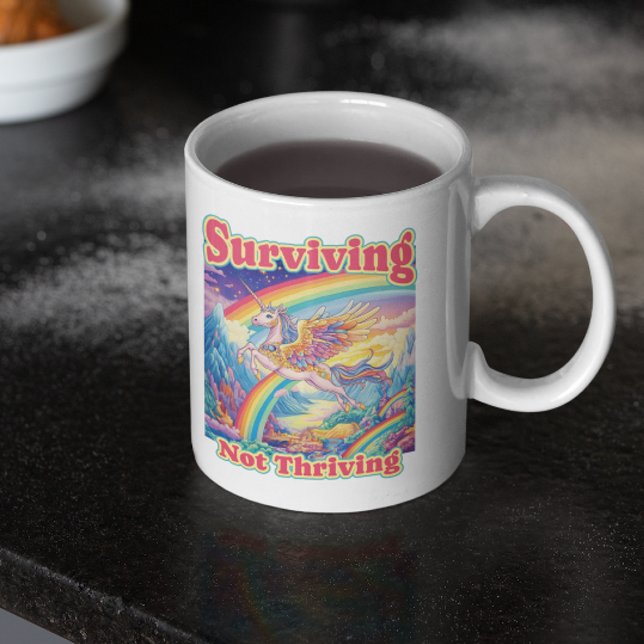 Surviving Not Thriving – Rainbow Unicorn Mug (Creator Uploaded)