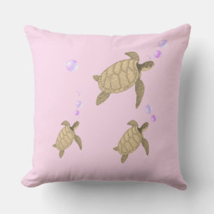 Swimming sea turtles on rose gold cushion
