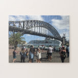 Sydney Harbour Bridge & Cruise Ship | Australia Jigsaw Puzzle<br><div class="desc">A photograph landmark jigsaw puzzle of The Sydney Harbour Bridge, which is an Australian heritage-listed steel through arch bridge across Sydney Harbour. Underneath the bridge is a cruise ship passing through and the hustle of people during the summer. The view from the bridge, the harbour and the nearby Sydney Opera...</div>