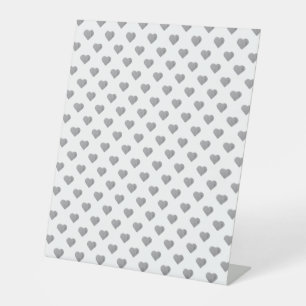 Symmetric Small Concrete Grey Hearts on White Pedestal Sign
