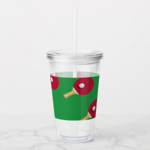 Table tennis racket and ball on green acrylic tumbler