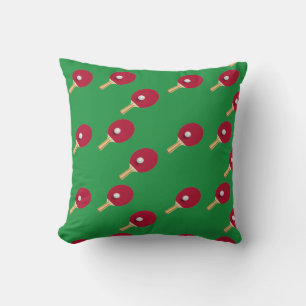 Table tennis racket and ball on green cushion