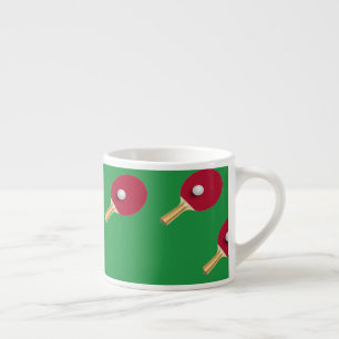 Table tennis racket and ball on green espresso cup