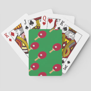 Table tennis racket and ball on green playing cards