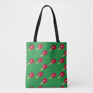 Table tennis racket and ball on green tote bag