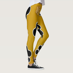 Tan and black paw print on a gold background #2 leggings