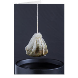 Tea bag is hung in a cup