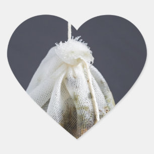 Tea bag is hung in a cup heart sticker