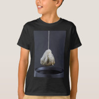 Tea bag is hung in a cup