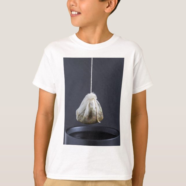 Tea bag is hung in a cup T-Shirt (Front)