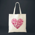 Teaching Is a Work of Heart Tote Bag<br><div class="desc">A bold and inspiring typography design featuring the phrase “Teaching Is a Work of Heart” arranged in a heart shape. The vibrant pink lettering and playful retro-style font create a warm and motivational design that celebrates the dedication and passion of teachers.</div>