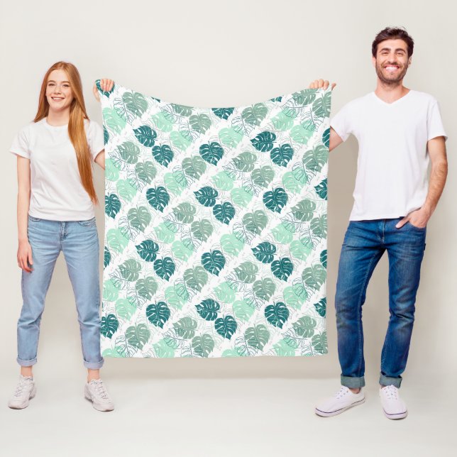 Teal and grey monstera leaves patterned fleece blanket (In Situ)