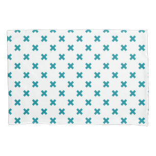 Teal cross stitches on white pillowcase