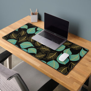 Teal green gold broad leaves pattern on black desk mat