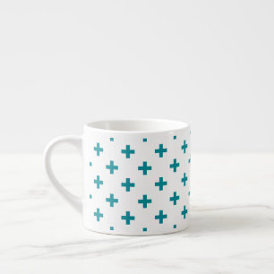Teal polka crosses on white espresso cup