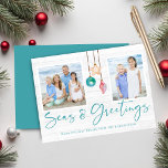 Teal Seas and Greetings Coastal Wood Holiday Photo<br><div class="desc">Teal Seas and Greetings Seashell Ornament on Coastal Wood Holiday Photo Christmas Cards featuring ocean teal blue and sandy tan shell ornaments hanging from sailing jute rope on coastal shiplap wood with elegant typography. Add two of your photos and a personal message for a fun nautical holiday card. Please contact...</div>