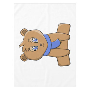 Teddy bear wearing a blue scarf tablecloth