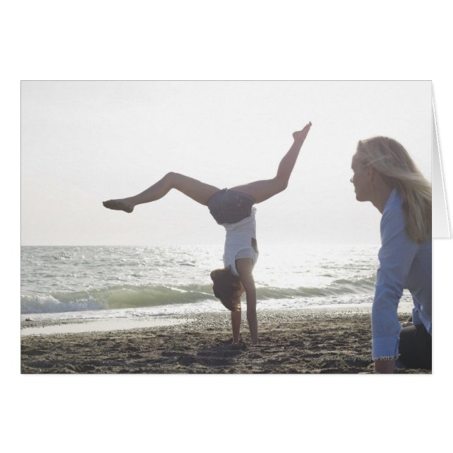 Teenage girl performs gymnastic feat, mum (Front Horizontal)