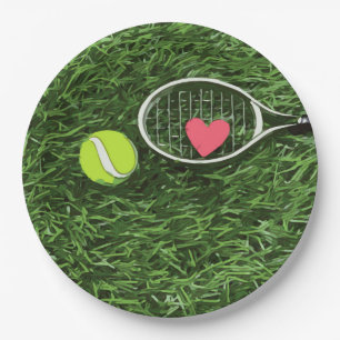 Tennis ball and racket on green background paper plate