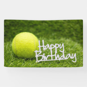 Tennis ball with happy birthday word on green banner
