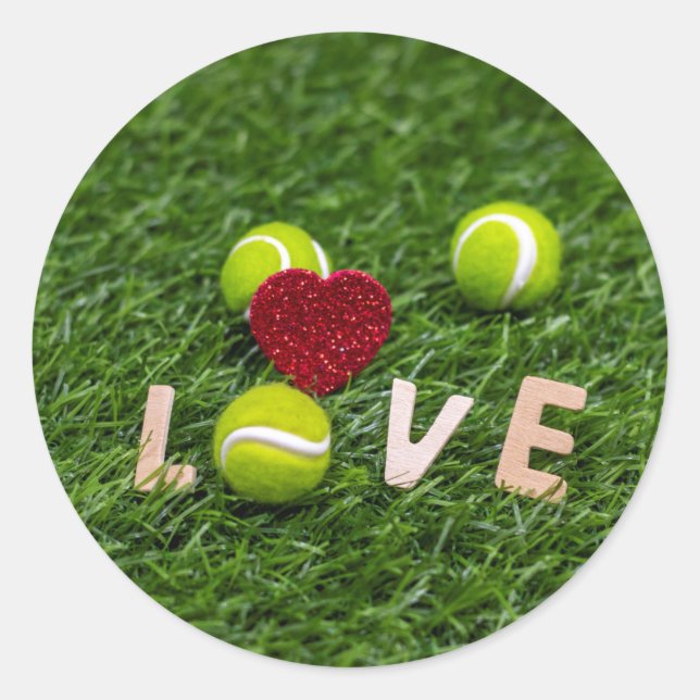 Tennis ball with love on green grass classic round sticker (Front)