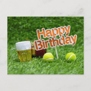 Tennis birthday with ball and gifts on green grass postcard