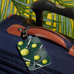 Tennis racket and ball on green grass luggage tag