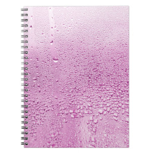 Texture of a drop of rain on a glass wet transpare notebook