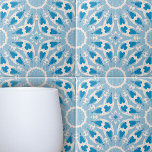 Textured Blue White Stylised Symmetrical Floral Tile<br><div class="desc">The design of this ceramic tile design is dominated by stylised floral motifs, arranged harmoniously across the tile. The colour palette is a soothing spectrum of varying shades of blue, creating a striking contrast and depth that draws the eye. The background texture adds an additional layer of visual interest, enhancing...</div>