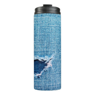 Textured denim background. Torn hole in the fabric Thermal Tumbler
