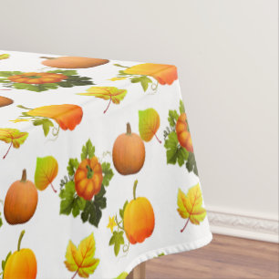 Thanksgiving Pumpkins and Fall Leaves on White Tablecloth