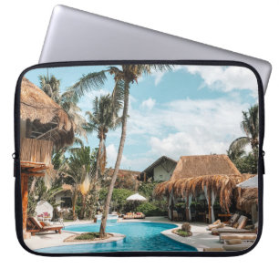 Thatch huts and houses by the pool during day laptop sleeve