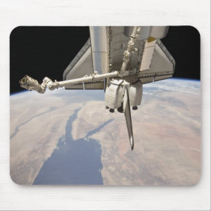 The aft section of the docked space shuttle mouse pad