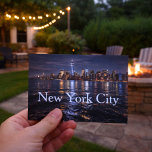 The Allure of New York City  Postcard<br><div class="desc">Capture the magic of the city that never sleeps with this stunning New York City skyline postcard. Featuring the illuminated Manhattan skyline glowing against the night sky and reflecting across the water, this striking cityscape showcases the energy, beauty, and iconic architecture that make NYC unforgettable. Perfect for travelers, city lovers,...</div>
