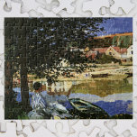 The Bank of the Seine, Bennecourt by Claude Monet Jigsaw Puzzle<br><div class="desc">On the Bank of the Seine, Bennecourt (1869) by Claude Monet is a vintage impressionism fine art nature painting. A portrait of a woman sitting under a shade tree on the banks of the Seine River. She is sitting near boats and rowboats with buildings on the other side of the...</div>