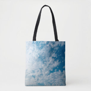 The clear sky during the day when the light passed tote bag
