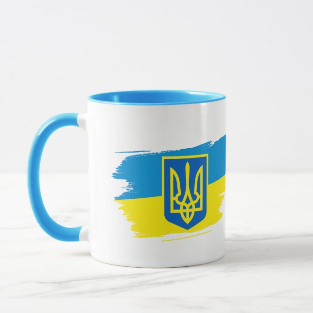 The coat of arms of Ukraine on the state flag Mug (Left)