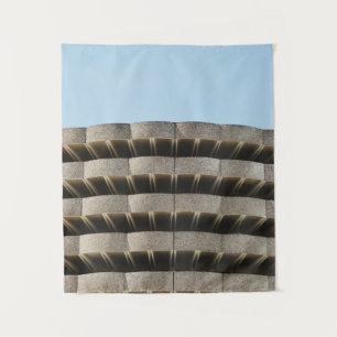 The concrete exterior of a multi-story parking lot tapestry