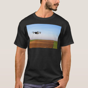 The drone is flying over the ploughed field 1 T-Shirt
