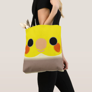 The face of a cinnamon pied male cockatiel tote bag