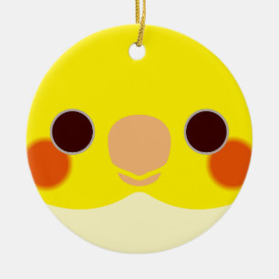 The face of a lutino cockatiel ceramic tree decoration