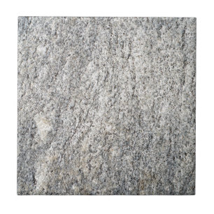 The flat surface of a grey granite stone tile