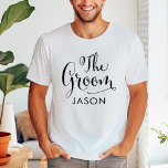 The Groom Black Script Personalised Wedding T-Shirt<br><div class="desc">Wedding Groom shirt features modern black swirling calligraphy script writing with elegant custom first name text that you can personalise. See our coordinating bridal party designs!</div>