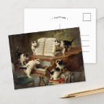 The Kittens’ Recital | Carl Reichert Postcard<br><div class="desc">The Kittens’ Recital (1908) | Carl Reichert’s The Kittens’ Recital is a charming and imaginative painting featuring five adorable kittens gathered around a piano, seemingly performing a recital. Each kitten’s unique pose and playful expression bring personality to the scene, while the finely rendered piano and cosy interior add depth and...</div>