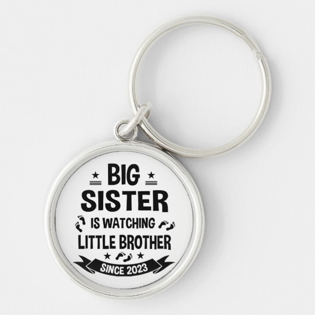 The little sister takes care of the big brother in key ring (Front)