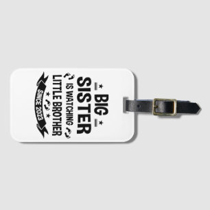 The little sister takes care of the big brother in luggage tag