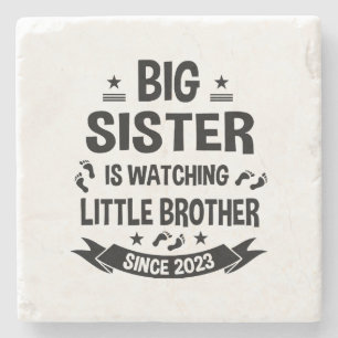 The little sister takes care of the big brother in stone coaster