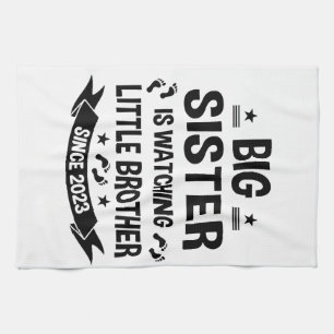The little sister takes care of the big brother in tea towel