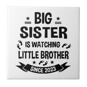 The little sister takes care of the big brother in tile